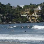 Tourists surfing in the sea, Sayulita, Nayarit, Mexico - Punta Mita Vacation Rental - Casa Joya Del Mar